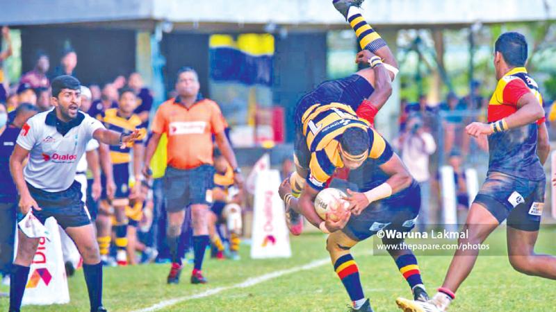 Royal winger Duljaya Gamanayake is tackled by a Trinity defender in their dispute-ridden inter school league rugby match (Pic Thepapare)