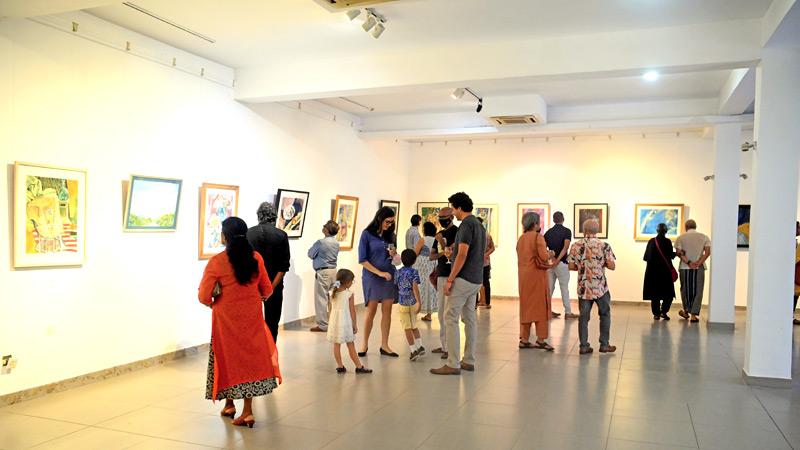 Guests at the gallery viewing the works of Beven. 