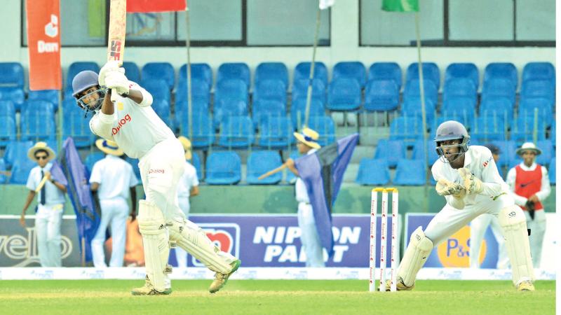 Royal College’s Uvindu Weerasekera plays a shot on his way to a half century on the second day of the 143rd Battle of the Blues match at the SSC ground on Friday (Pic by Chinthaka Kumarasinghe)