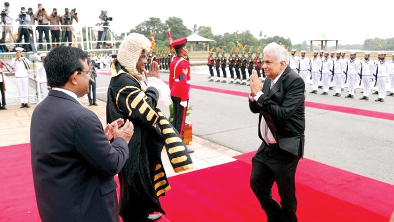 On his arrival at the Parliament, President Ranil Wickremesinghe is welcomed by Speaker Mahinda Yapa Abeywardena and Secretary General of Parliament Dhammika Dasanayake.