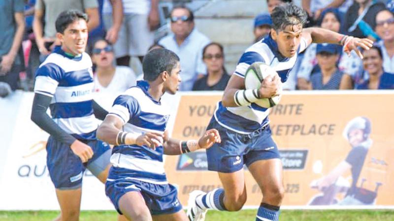 St. Joseph’s College centre Tehan Karunanayake  makes a break