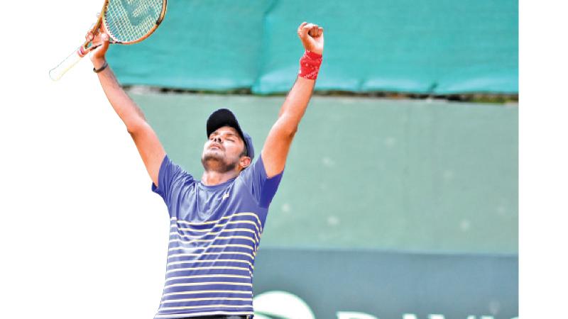 Godamanna raises his hands after his victory in his farewell game that was against Adel Mustapha of Iraq