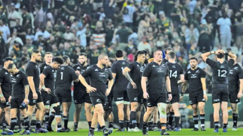 The New Zealand All Blacks team leave the field after losing to South Africa