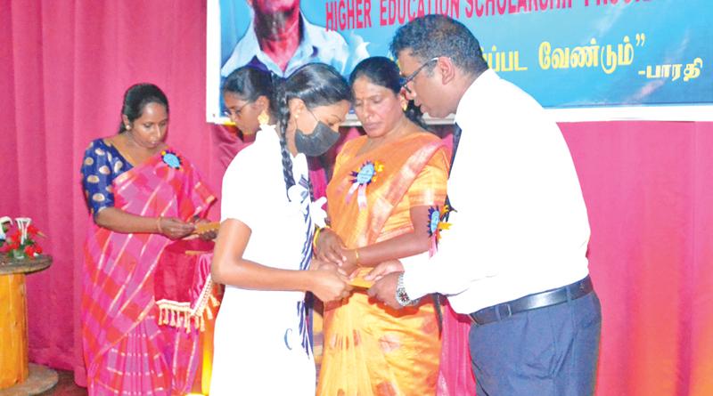Project Director of IMHO Upcountry Kandiah Vigneshwaran presents a scholarship to an Advanced Level student. Chairman of Maskeliya Pradeshiya Sabha G.Sembagawally was also present.
