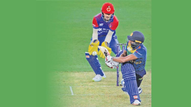 Bhanuka Rajapakse sweeps a ball to the boundary during his innings of 38 before he was run-out