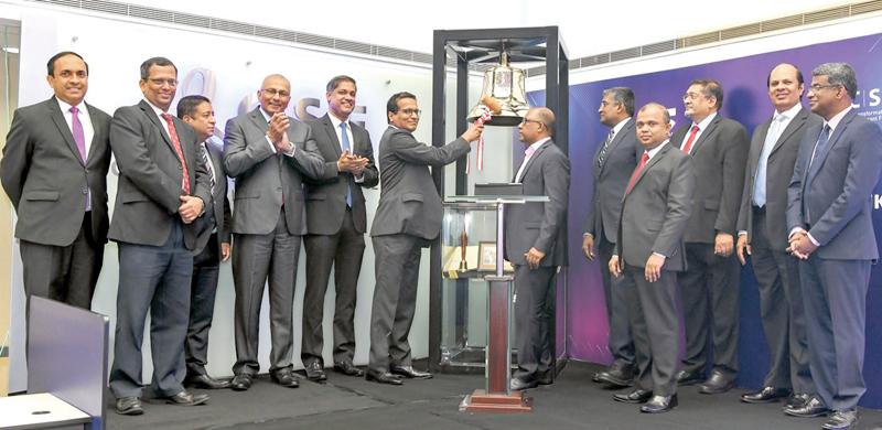 The bell-ringing ceremony. From left: CSE CEO, Rajeeva Bandaranaike, CSE Director, Jayantha Fernando, CSE Director, Dimuthu Abeywardena, CSE Director, Ray Abeywardena, CSE Chairman, Dilshan Wirasekara, SEC Chairman, Viraj Dayaratne PC, SEC/CSE Joint Committee Chairman for Digitalization, Naresh Abeyesekara, SEC DG, Chinthaka Mendis, SEC Commission Member, Sanjaya Bandara, SEC Commission Member, Manil Jayesinghe, CSE Director, Arjuna Herath and SEC Commission Member, Sanjeewa Dissanayake