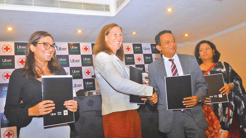 Uber and Red Cross officials after signing the agreement. Pic: Sudath Nishantha