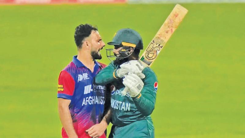 Pakistan batsman Asif Ali (right) raises his bat in reaction after Afghanistan bowler Fareed Ahamad had his wicket and celebrated by apparently throwing mock punches in the face of Ali