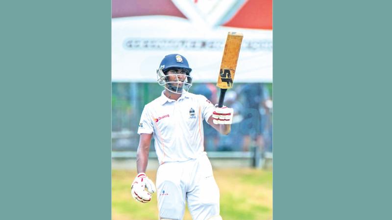 Vinuda Liyanage celebrates one of his feats with the bat
