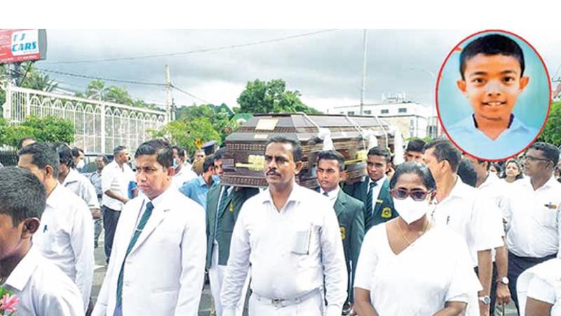 The grieving parents along with school staff and family members accompanying the coffin of the dead boy to the cemetery along with the prefects of the school