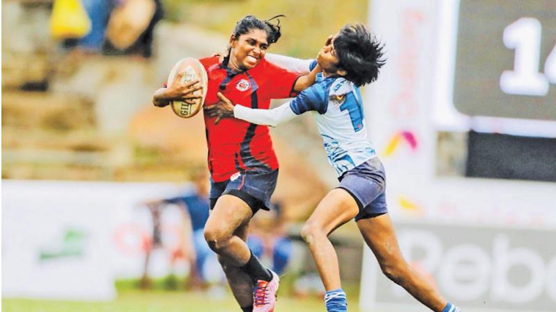 Kanchana Kumari Mahendran handing off a tackler in a tournament four years ago like a classic winger