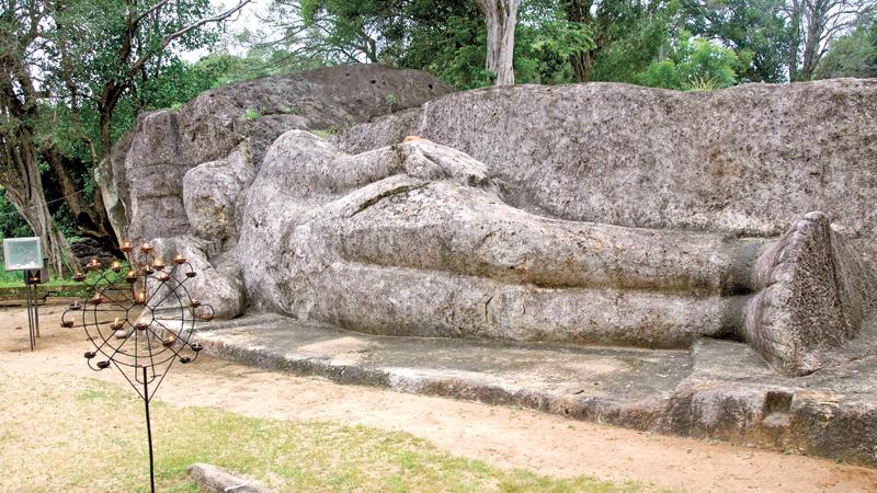 The rock-hewn recumbent Buddha statue  at Ataragalleva in Elahera