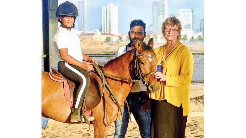 A student at the horse riding club with Chairperson Ineke Ann Pitts.  Pic: Sudath Nishantha