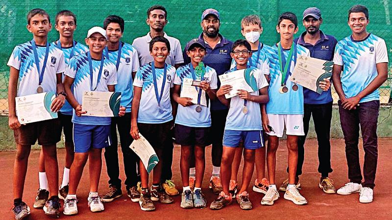 St. Joseph’s College tennis squad after their triumph.  Front row: Nisal Anjelo, Nathan de Zylva, Thenuk Nanayakkara, Neven Mendis, Avin Dias. Back row: Avish Cooray, Anish, Lakshan (junior coach), Pahitharan (head coach), Caleb de Alwis, Minuka Alexander, Pradeep (junior coach) and Thivain Vithanage (captain)