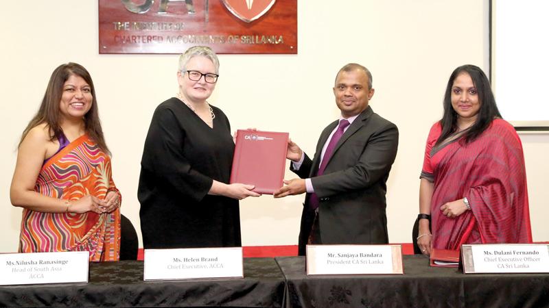 CA Sri Lanka President Sanjaya Bandara and ACCA global Chief Executive Ms. Helen Brand exchange the agreement. ACCA Head of South Asia Ms. Nilusha Ranasinghe and CA Sri Lanka Chief Executive Officer Ms. Dulani Fernando look on.