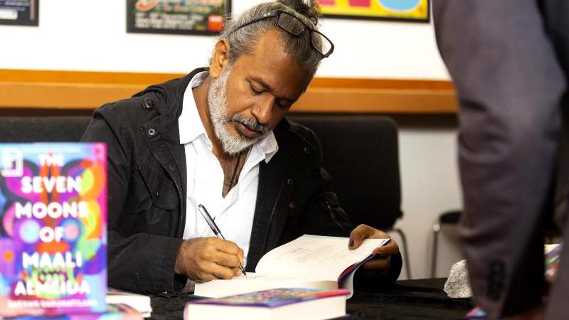 Shehan Karunatilaka signs books for guests at a Booker Prize 2022  David parry/Booker Prize Foundation