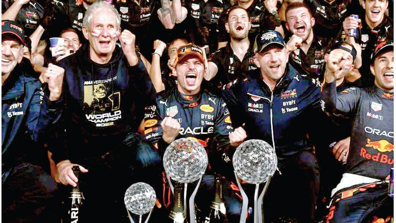 Red Bull Racing’s Dutch driver Max Verstappen (front C) celebrates winning the season’s world championship with his team after his victory at the Formula One Japanese Grand Prix at Suzuka