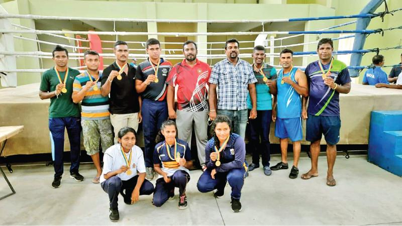 The gold medal winners (standing from left) BRLS Kumara, YGI Herath, PARS Rupasingha, KSS Kumara, Darshana Bandaranayaka (Sports Officer), TS Hewa (District Sports Officer), DBADD Bandara, RHAJ Rathnaweera, AMIH Abeysingha; (squatting from left) RPHS Bandara, DMPDP Dissanayaka and DAIM Arachchi