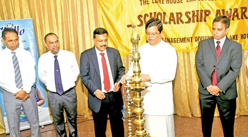 Media Minister Dr. Bandula Gunawardana lighting the oil lamp. 