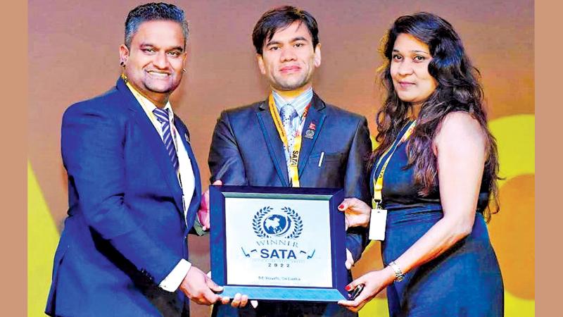 President of Hotel Association in Nepal, Tekendra Mahat presents the  award to Chairman, DT Travels, Destry Bartholomeusz 