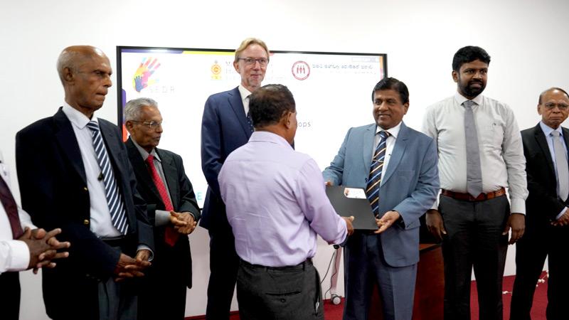 Minister of Justice Dr. Wijeyadasa Rajapakshe provides laptops to the Mediation Boards Commission