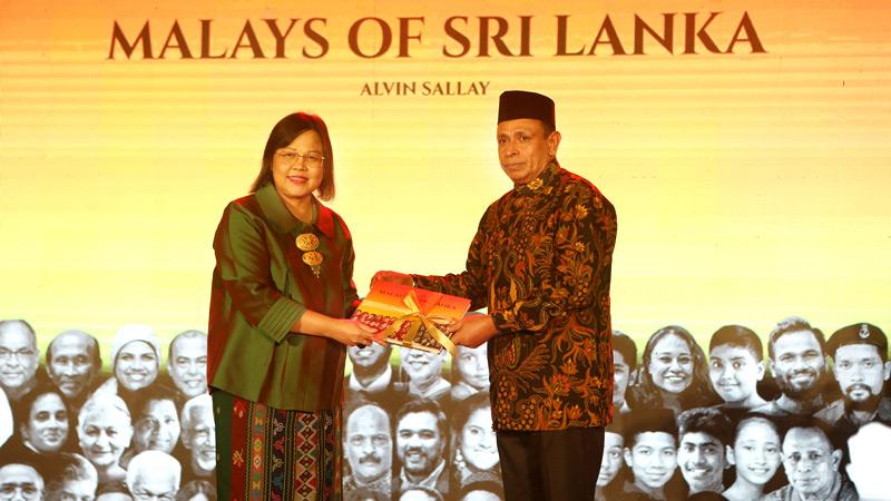 First copy of the book presented to Her Excellency DewiGustinaTobing, The Ambassador of the Republic of Indonesia to Sri Lanka by Deshabandu M.R. Latiff, Senior DIG (retired), Chair of the Book Committee of the Colombo Malay Cricket Club.