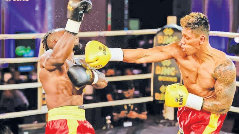 Tharindu Madushanke lands a blow on Uganda’s Tamale Lawrence during their fight in Colombo