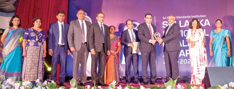 Members of the Commercial Bank team led by Managing Director and CEO Sanath Manatunge (fourth from right) and Chief Operating Officer S. Prabagar (fifth from left). The award was presented by State Minister for Technology Kanaka Herath (third from right) and Sri Lanka Standards Institution Chairman Asanga Ranasinghe (fifth from right).