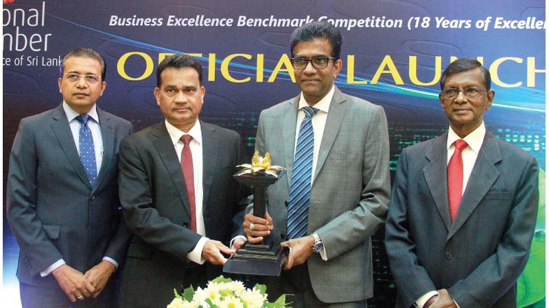 Chairman, Technical and Financial Evaluation, Sanath Fernando, Senior Deputy President, NCCSL, Deepal  Nelson,  President of the NCCSL, President Nandika Buddhipala and Chairman NEBA Panel of Judges, Sunil G. Wijesinghe unveil the NBEA 2022 trophy.     Pic: Thushara Fernando
