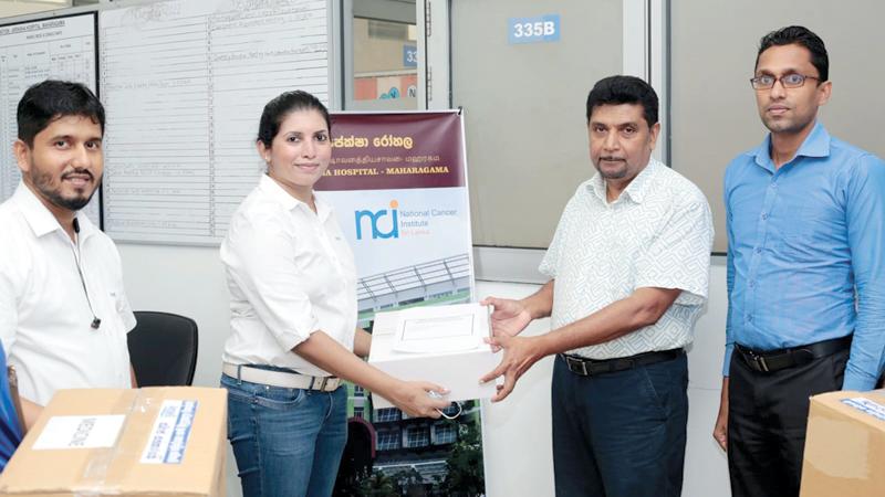 General Manager of Ansell Textiles, Ms. Anuradha Wimaladasa makes a token presentation of the goods to  Director,  Apeksha Hospital, Dr. Aruna Jayasekara  and Administrative Officer Pradeep  Rasanga.