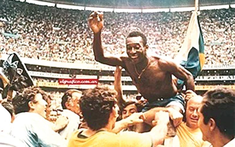 Pelé being held aloft after winning the 1970 World Cup Final in Mexico City. He is the only player to win three World Cups.