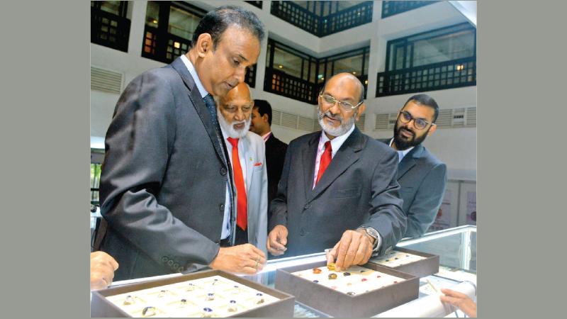 Minister Dr. Ramesh Pathirana discusses with a Sri Lankan gem exhibitor at the FACETS Sri Lanka Premier Edition Gem and Jewellery Exhibition at the Cinnamon Grand yesterday. Former Minister A.H.M. Fowzie was also present. Pic: Sudath  Nishantha