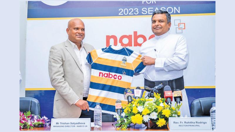Trishan Satyadheva (left) the Managing Director of Nabco and the rector of St. Peter's College Fr. Rohitha Rodrigo exhibit the team's new rugby jersey at a media launch 