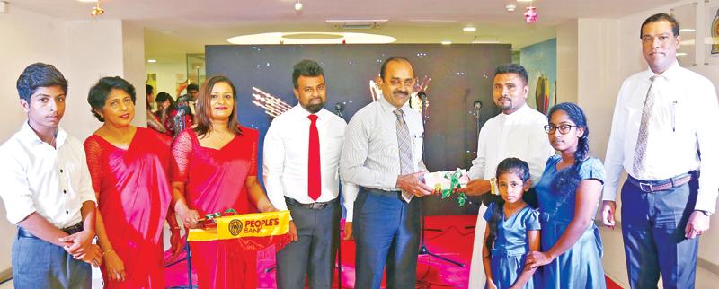 People’s Bank Chairman Sujeewa Rajapakse presents school equipment to Director, Nattandiya, Tummodara Santhana Lama Niwasaya, Rev. Fr. Pathum Nirmal.