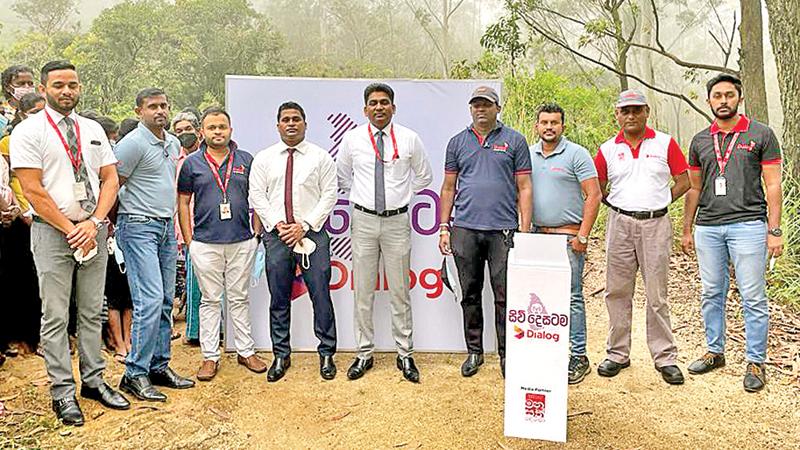 Representatives of Dialog at the site of the newly commissioned tower in Madolsima, Badulla
