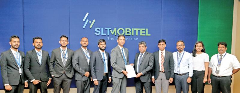 CEO, SLT, Janaka Abeysinghe and Managing Director, Itechro, Chamara Jayaweera exchange the signed agreement. Representatives of both companies look on