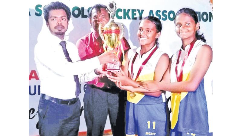 Musaeus hockey team captain Vinuri Nanayakkara and vice captain Keshani Perera receiving the trophy