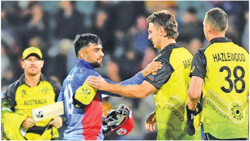 Rashid Khan (left) and Mitchell Marsh come together at a match in this file picture