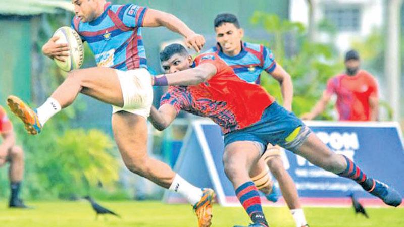 Air Force player Saraka Werralla averts a tackle from CR player Soyura Anthony  in their first round League rugby match last week