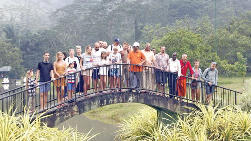 Minister Bandula Gunawardena and tour group at the Seethawaka Wet Zone Botanical Gardens.