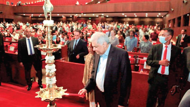 President Ranil Wickremesinghe lights the oil lamp