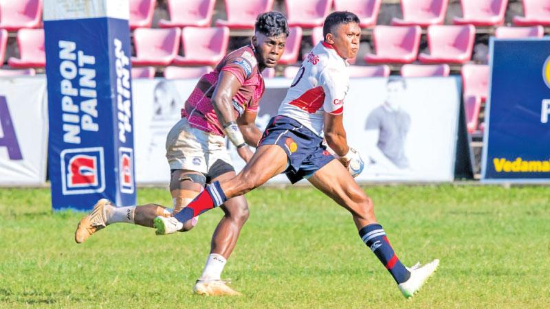 Kandy SC fly half Nigel Ratwatte makes a break against the Havelocks defence