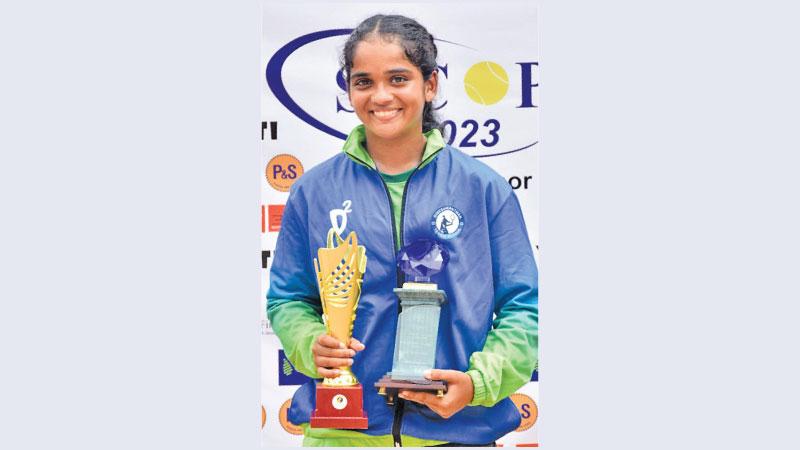 Saajida Razick with the Spirit of Tennis award and the women’s singles trophy
