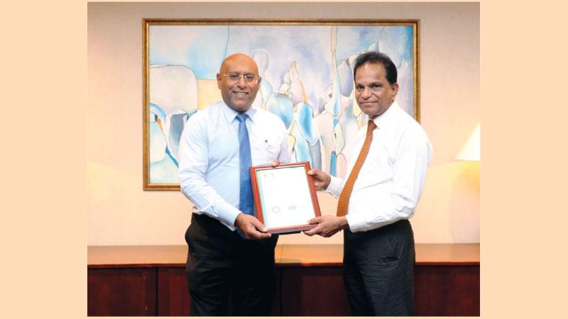 Director, Sri Lanka Climate Fund, Dr. B. M. S. Batagoda presents the certificate to NDB CEO Dimantha Seneviratne