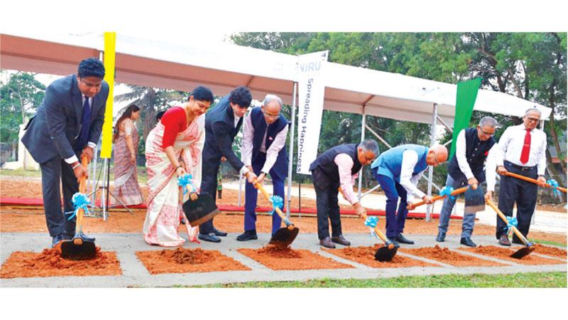 Indian High Commissioner Gopal Baglay,  BOI Director General Renuka M. Weerakone and officials cutting the first sod.  