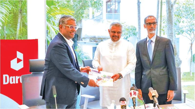 Managing Director, Daraz Sri Lanka, Rakhil Fernando presents a copy of the report to State Minister Kanaka Herath. Chairperson, SLASSCOM, Ashique M. Ali looks on.