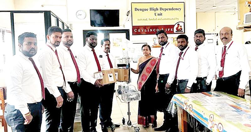 Ceylinco Life’s AGM, Business Development, K. Sumanthiran and Senior Manager, Business Development, T. Nirojan present the equipment to Chair Professor of Pediatrics, Prof. Githanjali Sathiadas at the Jaffna Teaching Hospital. Ceylinco Life’s heads of branches in the Jaffna region look on.