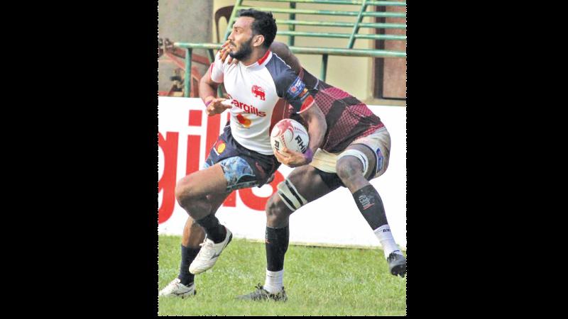 Kandy SC winger Kavindu Perera is held by a Havelocks defender