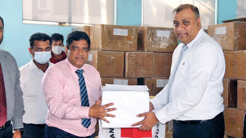 Country Manager for Microsoft Harsha Randeny makes a token presentation of the medicines to Deputy Director, Medical Supplies Division, Dr. A.T. Sudarshana