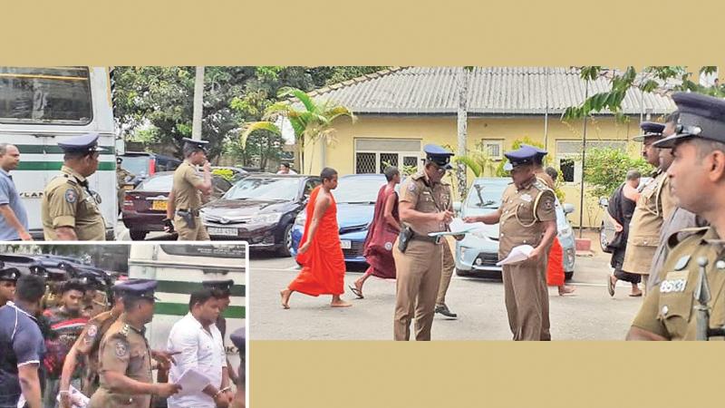 IUSF Convener Wasantha Mudalige and the monks at the Kaduwela Court premises yesterday.